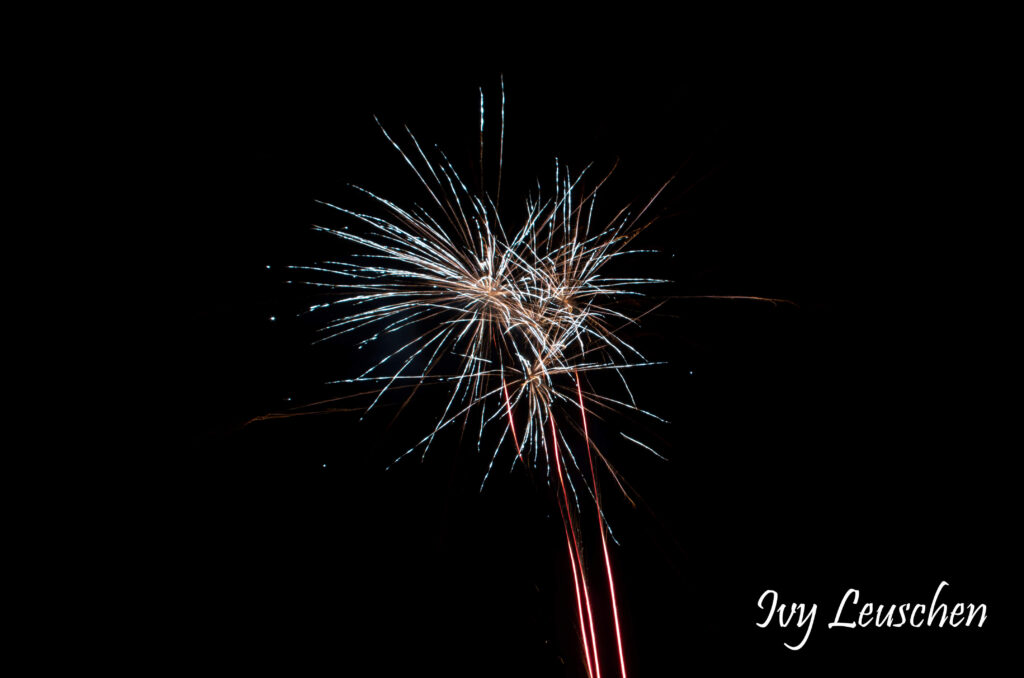 Aqua fireworks with red and white tail