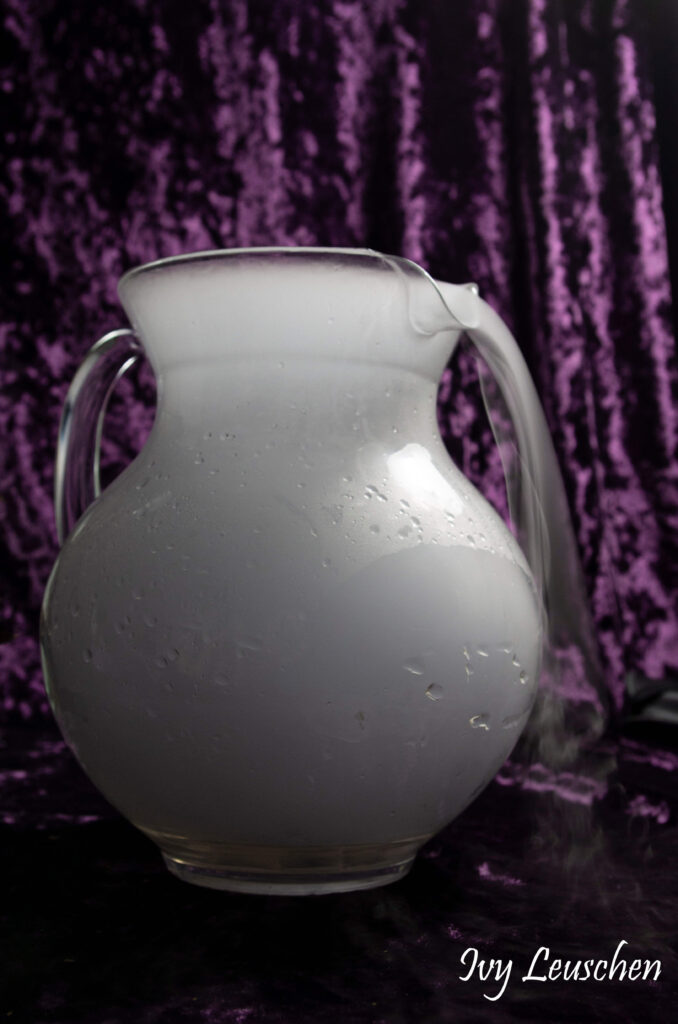 Fog pouring out of glass pitcher