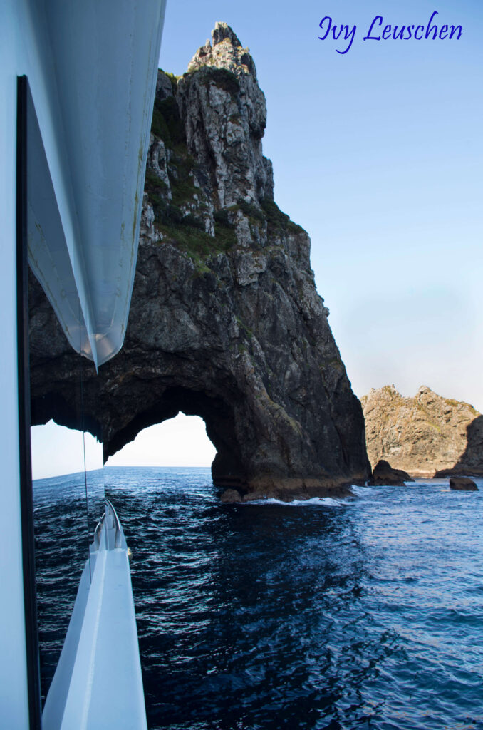 Hole in the rock reflection in boat window